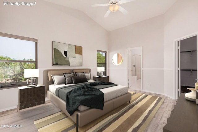 40713 N Courage Trl, Anthem, AZ 85086 - bedroom featuring light wood-style flooring, high vaulted ceiling, and ensuite bath