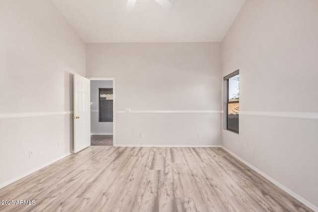 40713 N Courage Trl, Anthem, AZ 85086 - unfurnished room featuring wood finished floors, ceiling fan, and vaulted ceiling