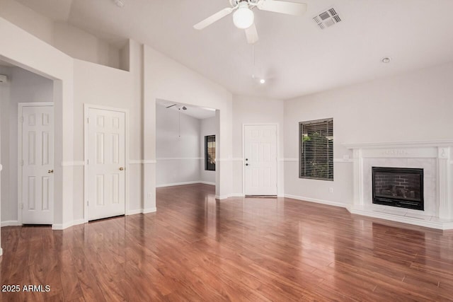 40713 N Courage Trl, Anthem, AZ 85086 - unfurnished living room with ceiling fan, lofted ceiling, wood finished floors, and a premium fireplace