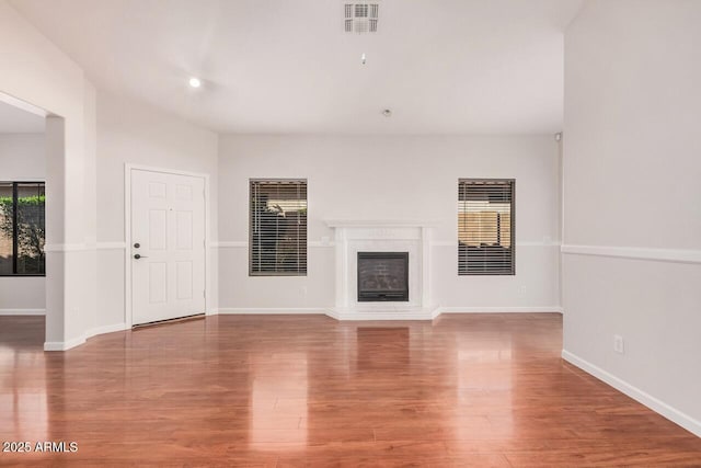 40713 N Courage Trl, Anthem, AZ 85086 - unfurnished living room with wood finished floors and a glass covered fireplace