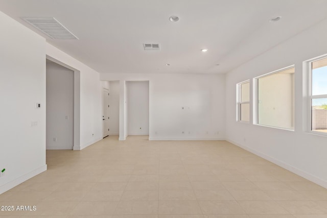 spare room with baseboards and recessed lighting