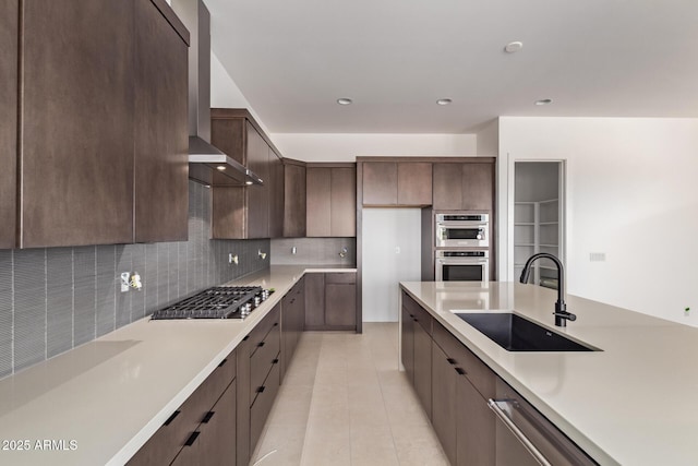 kitchen featuring a sink, stainless steel appliances, light countertops, and recessed lighting