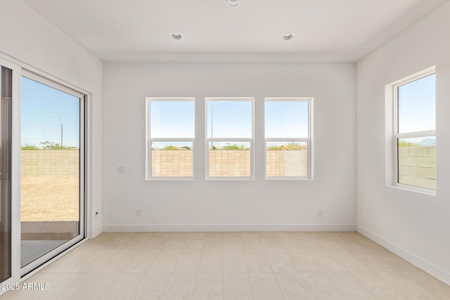 spare room featuring baseboards and recessed lighting