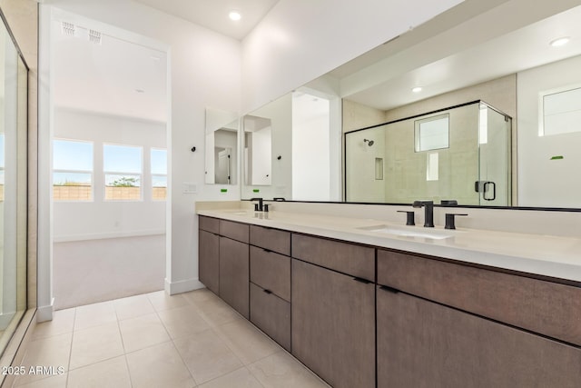 full bath with a stall shower, double vanity, tile patterned floors, baseboards, and recessed lighting