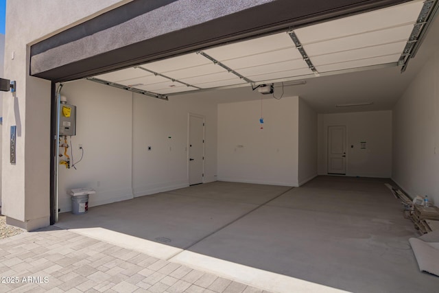 garage with a garage door opener and water heater