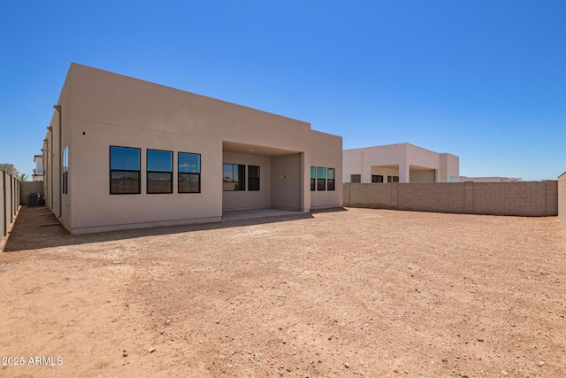 back of property featuring a fenced backyard, stucco siding, and a patio area