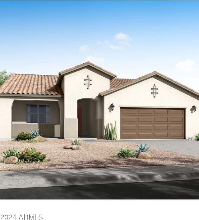 mediterranean / spanish-style house with driveway, a tile roof, and stucco siding