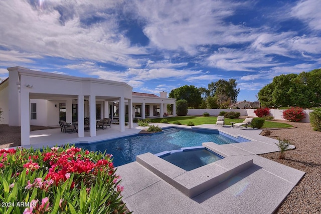 view of swimming pool featuring a patio area and an in ground hot tub