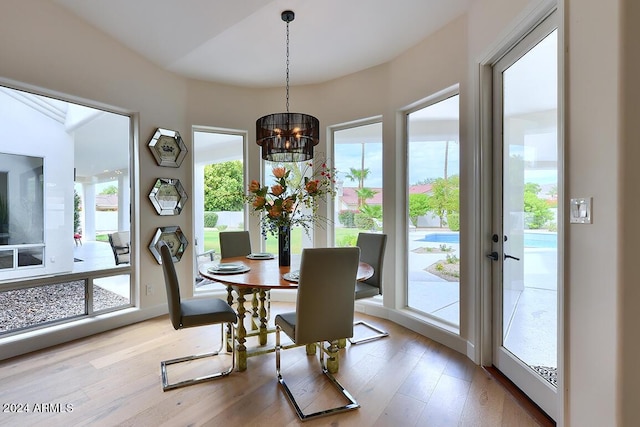 dining room featuring light hardwood / wood-style flooring and an inviting chandelier