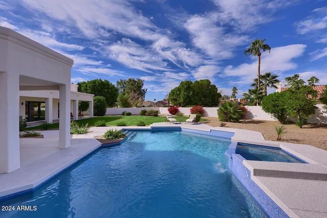 view of swimming pool with an in ground hot tub, a yard, pool water feature, and a patio area