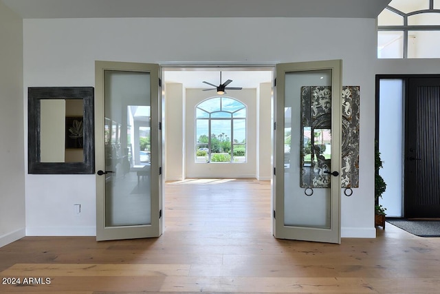 foyer entrance featuring ceiling fan and light wood-type flooring