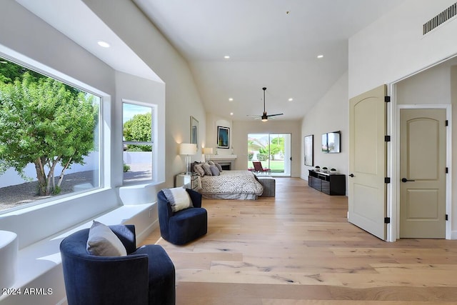 bedroom featuring high vaulted ceiling and light hardwood / wood-style flooring