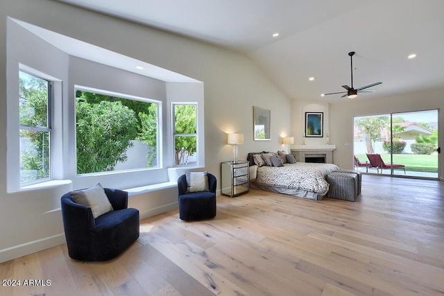 bedroom featuring access to outside, ceiling fan, vaulted ceiling, and light wood-type flooring