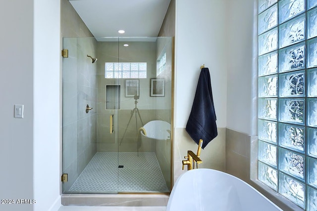 bathroom with shower with separate bathtub