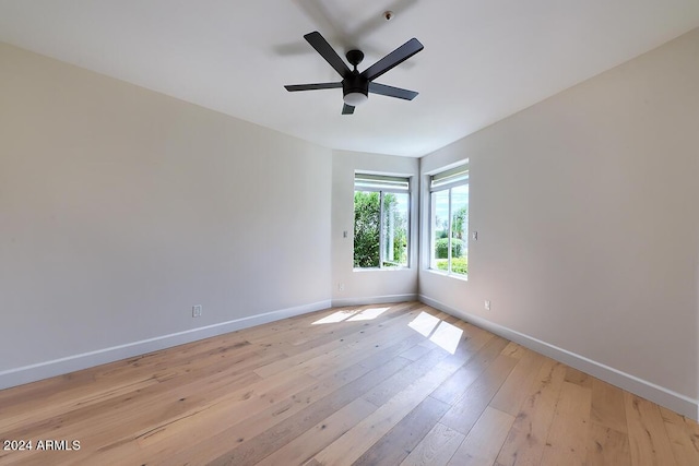 empty room with light hardwood / wood-style flooring and ceiling fan