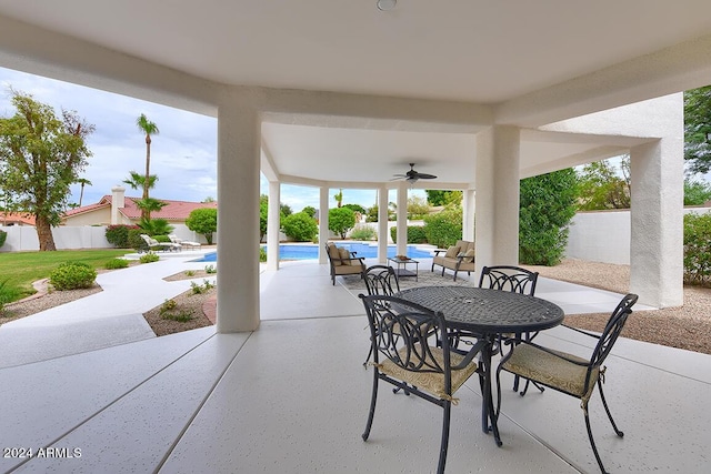 view of patio with a fenced in pool and ceiling fan