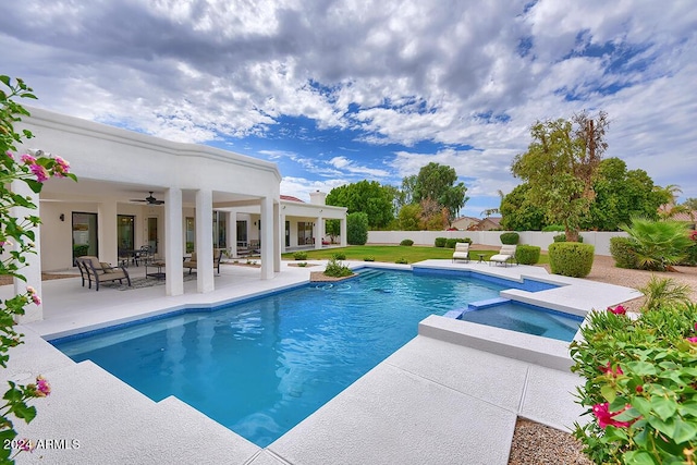 view of pool with an in ground hot tub, a patio, and ceiling fan