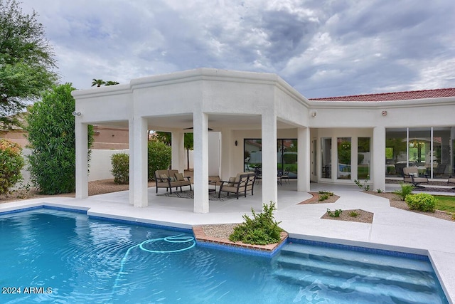 view of pool with an outdoor living space and a patio