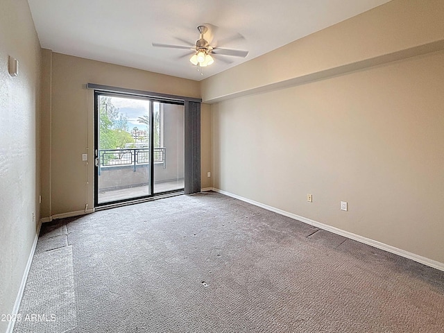 carpeted spare room with baseboards and ceiling fan