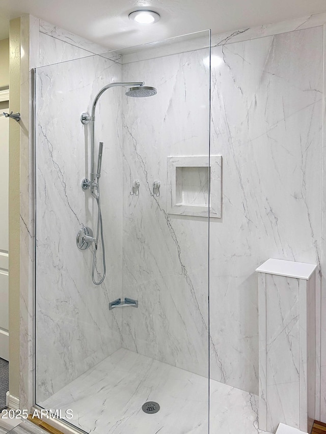 full bath featuring a marble finish shower