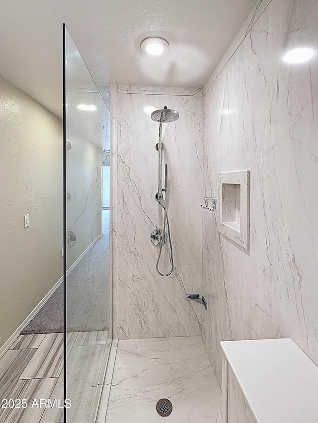 bathroom with a marble finish shower