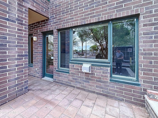 property entrance with brick siding