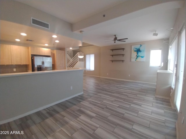 unfurnished living room featuring visible vents, baseboards, ceiling fan, recessed lighting, and stairs