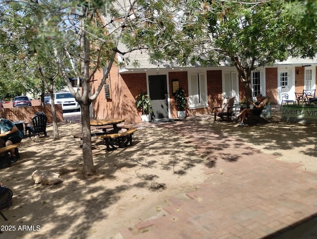 back of house featuring brick siding