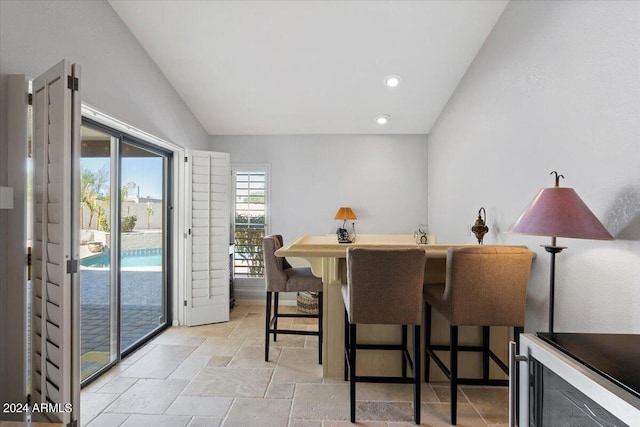 dining area featuring vaulted ceiling