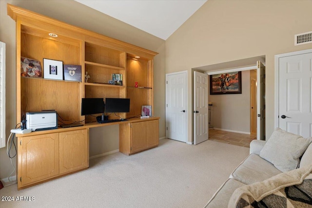 office with light colored carpet and high vaulted ceiling