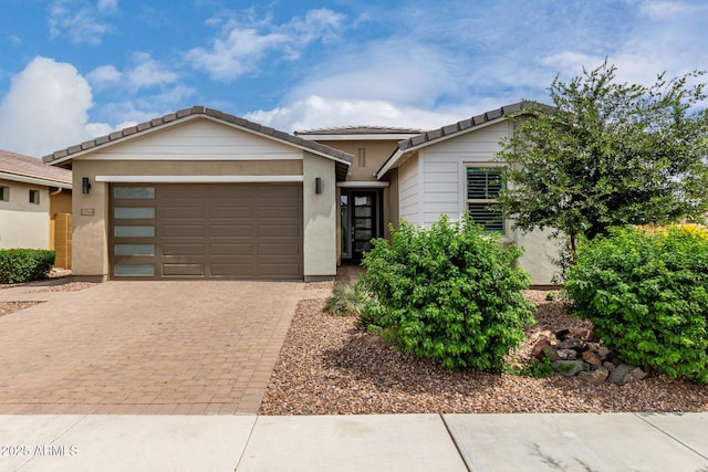 22568 E Rosa Rd, Queen Creek, AZ 85142 - view of front facade with a garage, a tiled roof, decorative driveway, and stucco siding