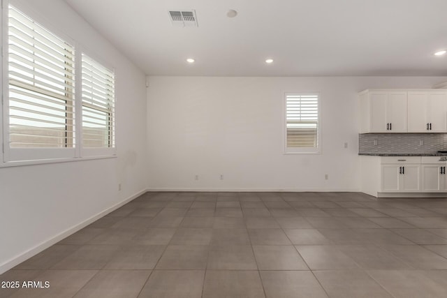 22568 E Rosa Rd, Queen Creek, AZ 85142 - unfurnished living room with light tile patterned floors, recessed lighting, and baseboards