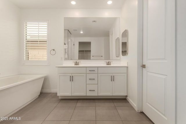 22568 E Rosa Rd, Queen Creek, AZ 85142 - bathroom with double vanity, a freestanding bath, baseboards, tile patterned flooring, and an enclosed shower