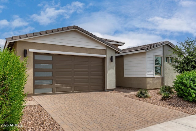 22568 E Rosa Rd, Queen Creek, AZ 85142 - view of front facade with decorative driveway, a garage, a tiled roof, and stucco siding