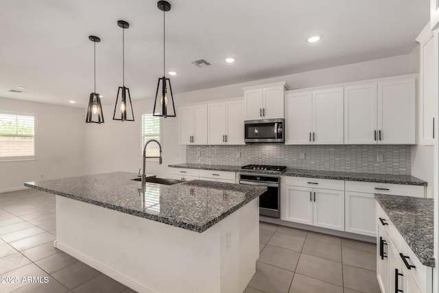 22568 E Rosa Rd, Queen Creek, AZ 85142 - kitchen with stainless steel appliances, a sink, backsplash, light tile patterned flooring, and white cabinets