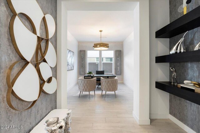 hallway with light hardwood / wood-style floors