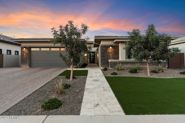 prairie-style house with a lawn and a garage