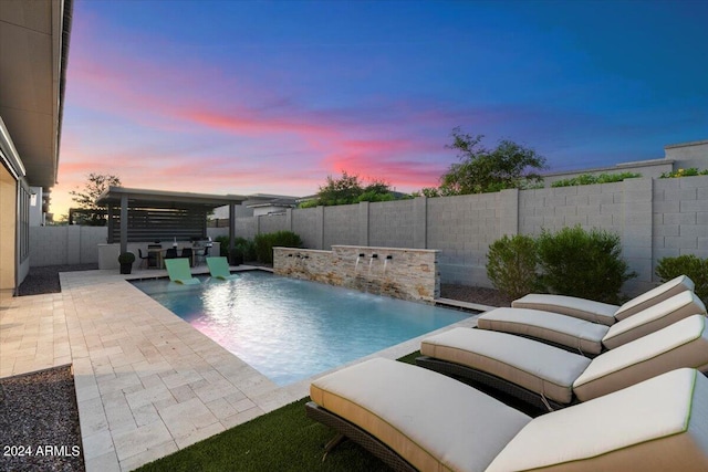 pool at dusk with a patio, a pergola, and pool water feature