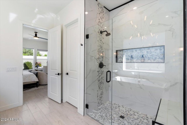 bathroom featuring an enclosed shower and ceiling fan