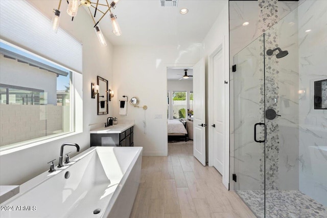 bathroom featuring vanity, ceiling fan, hardwood / wood-style flooring, and separate shower and tub