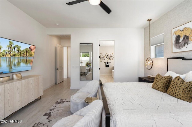 bedroom with hardwood / wood-style floors, ensuite bath, and ceiling fan