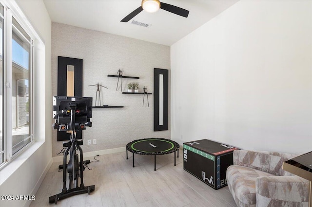 exercise room featuring wood-type flooring and ceiling fan