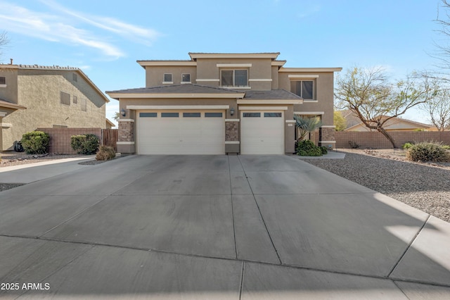 prairie-style house with an attached garage, driveway, fence, and stucco siding