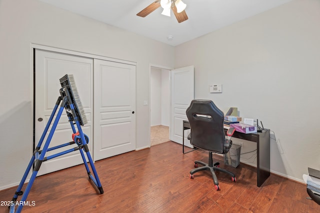 office area featuring ceiling fan, baseboards, and wood finished floors