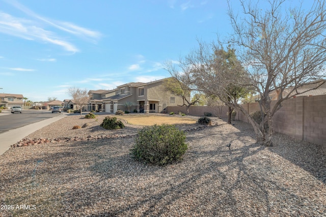 view of yard featuring a residential view and fence