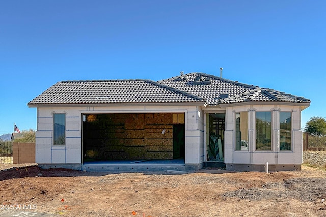 rear view of property featuring a garage