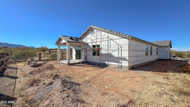 back of property with a mountain view