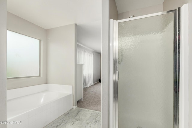 bathroom featuring a bath, marble finish floor, a healthy amount of sunlight, and a shower stall