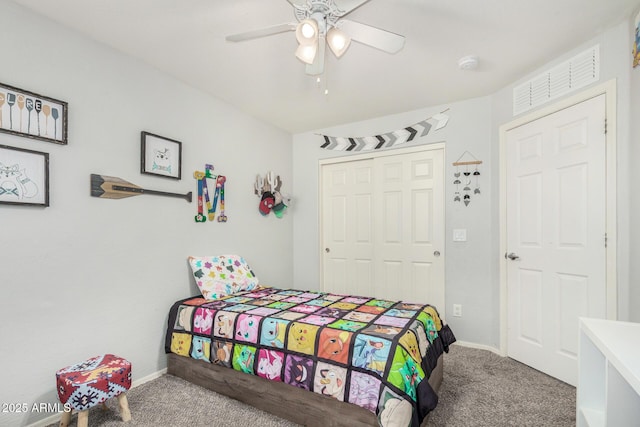 carpeted bedroom featuring visible vents, baseboards, a closet, and ceiling fan