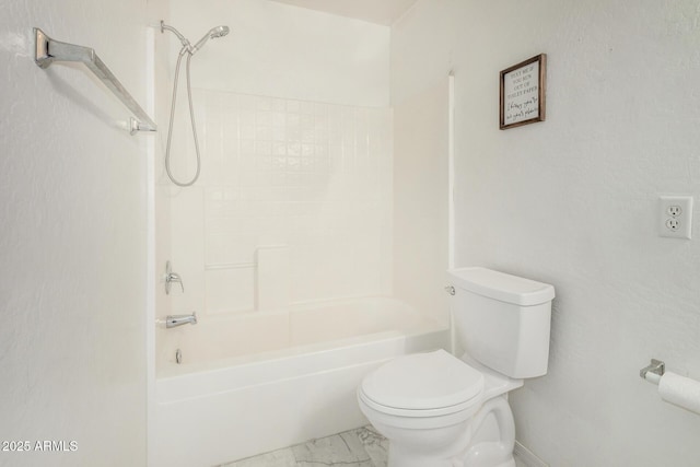 bathroom with marble finish floor, toilet, and washtub / shower combination